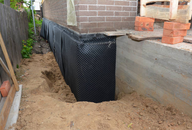 Happy homeowners after waterproofing job in Mount Sinai